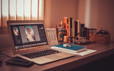 Warm-toned home office desk with a laptop, notebook, and books. Perfect for freelancers.